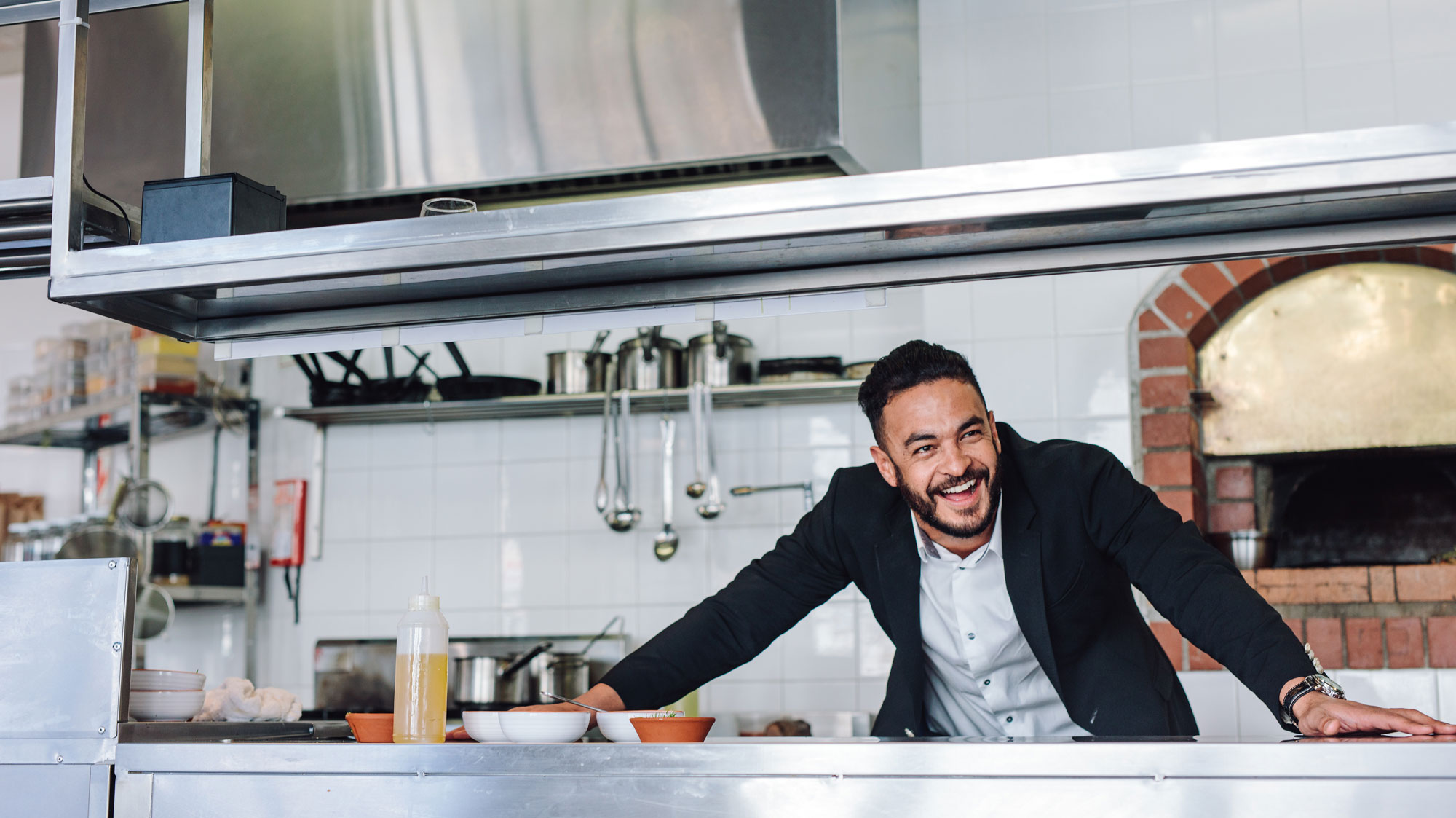 Man in kitchen smiling