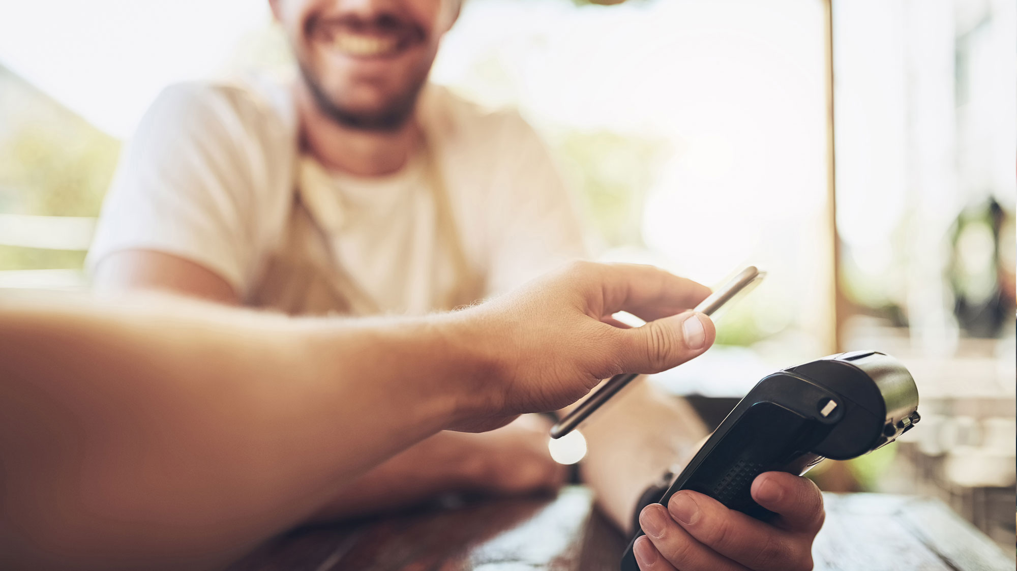 person paying with phone