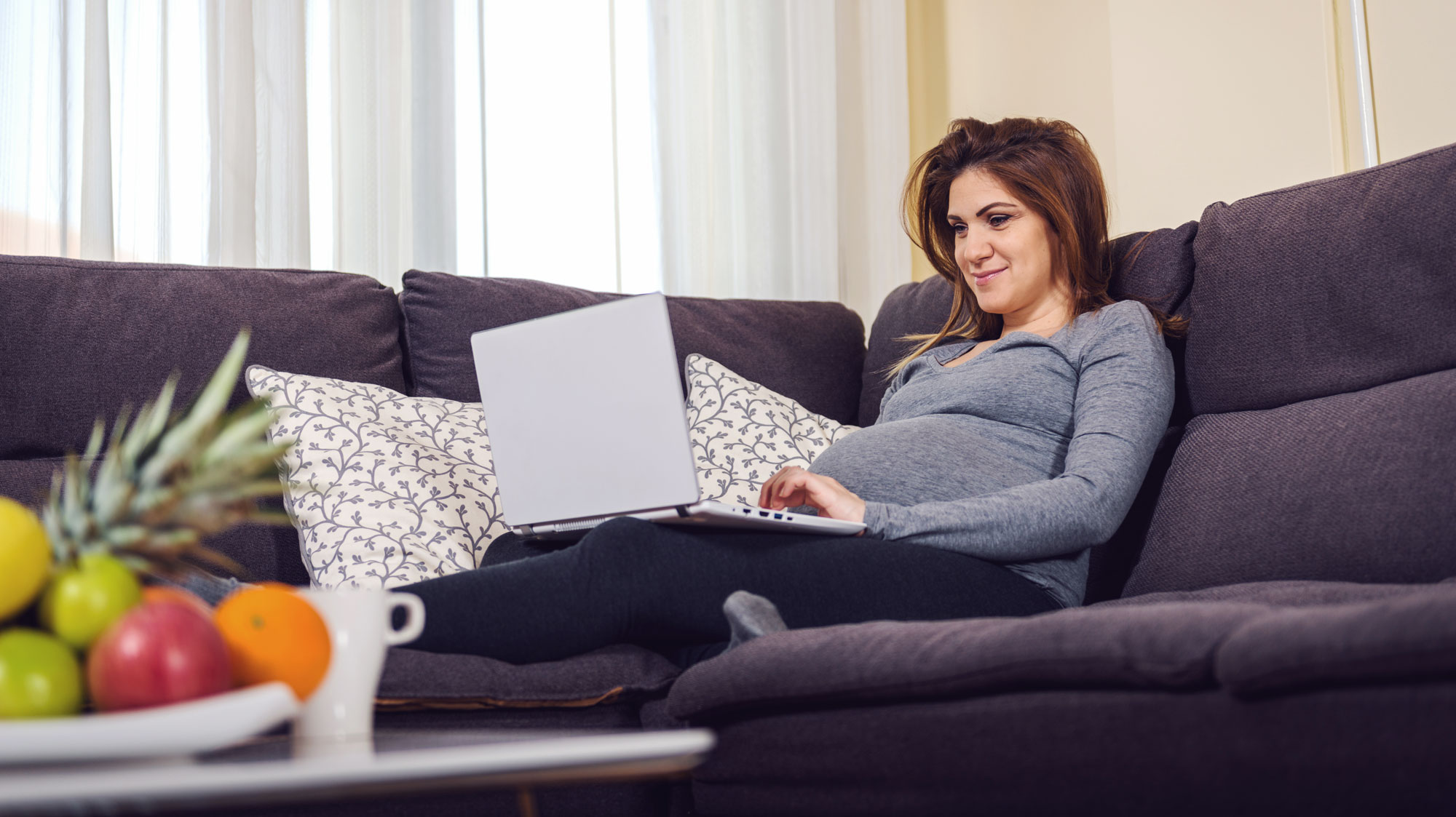 Woman on the couch on the computer