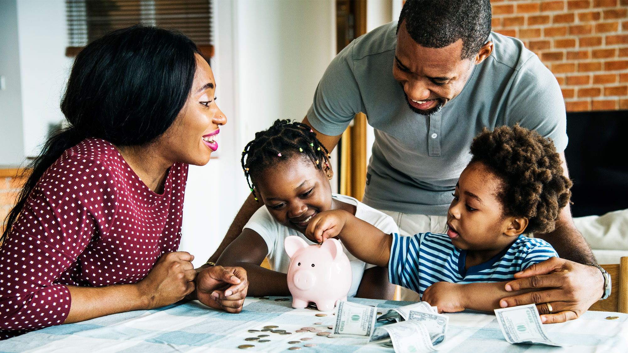 Children saving money in piggy bank, parents smiling