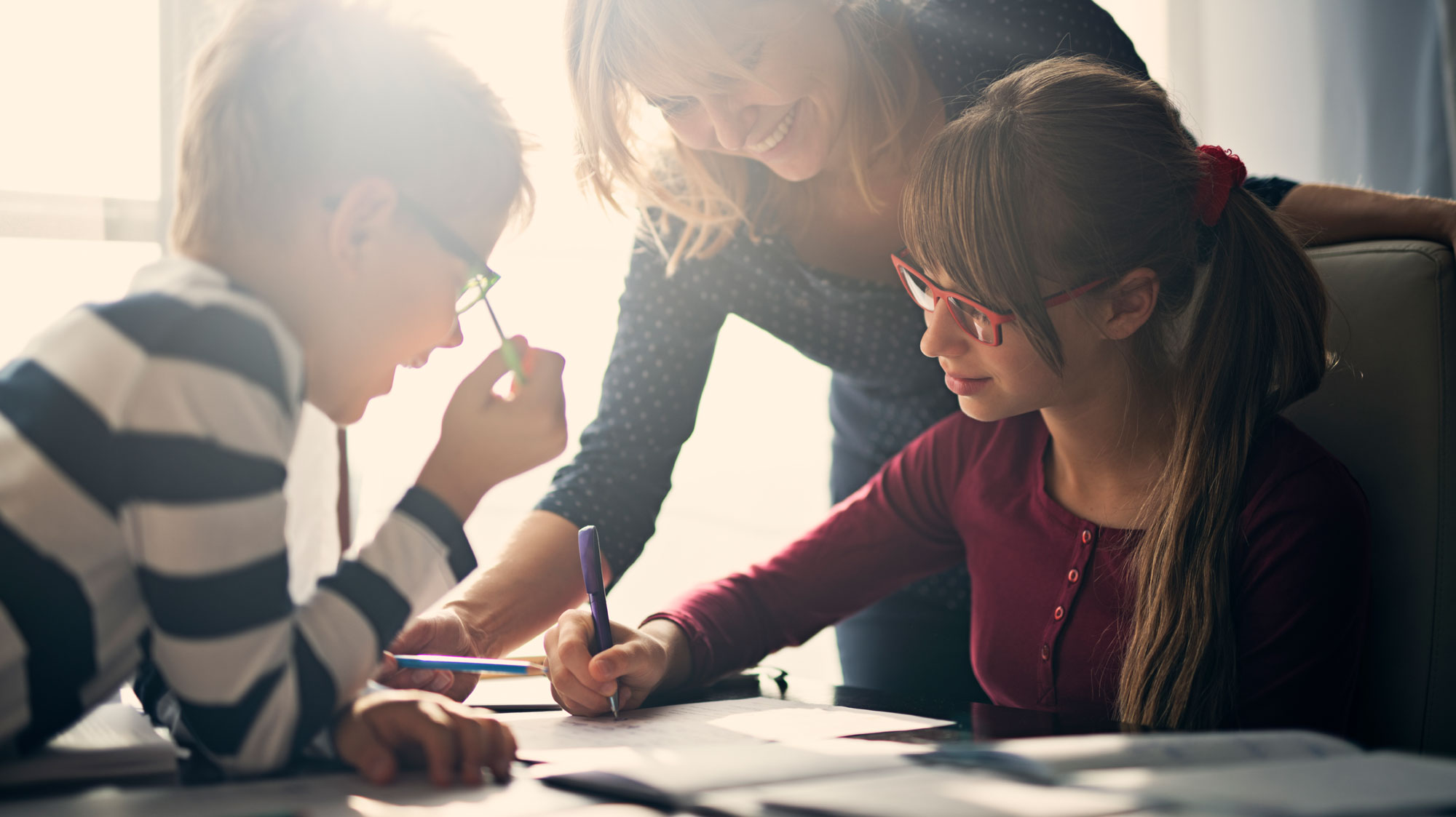 Mom helping children do homework