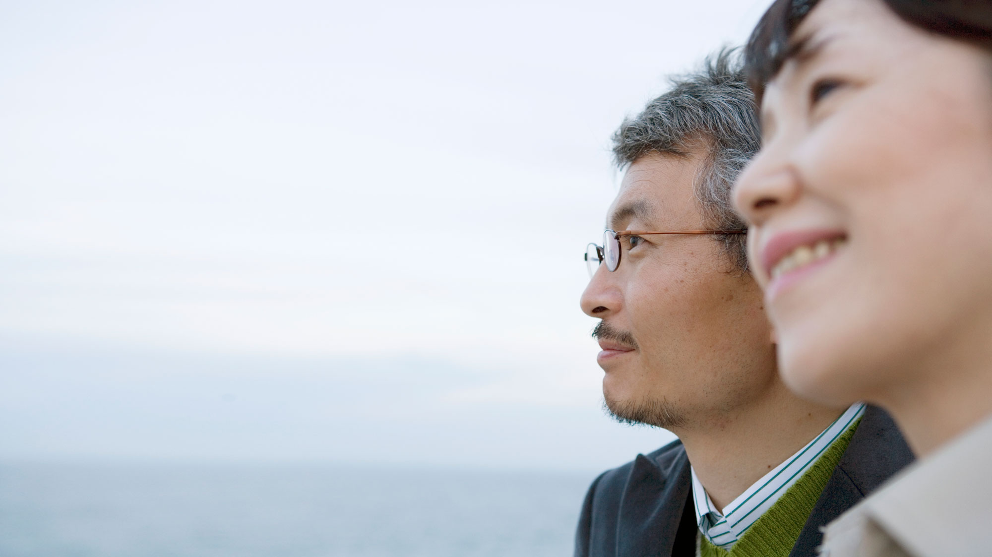 Couple smiling and looking into distance