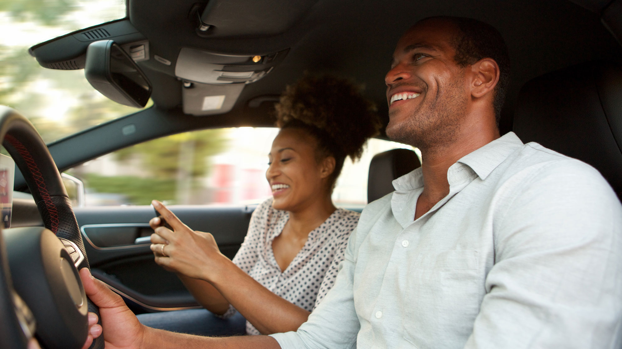 man and woman driving in a car