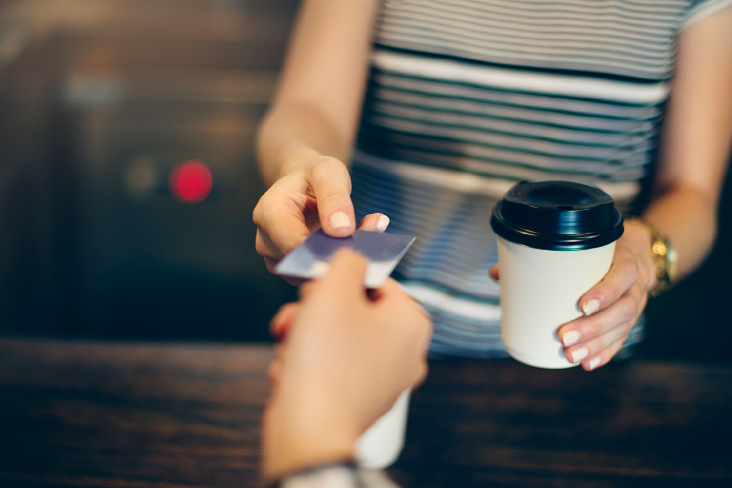 Photo of person buying coffee with debit card